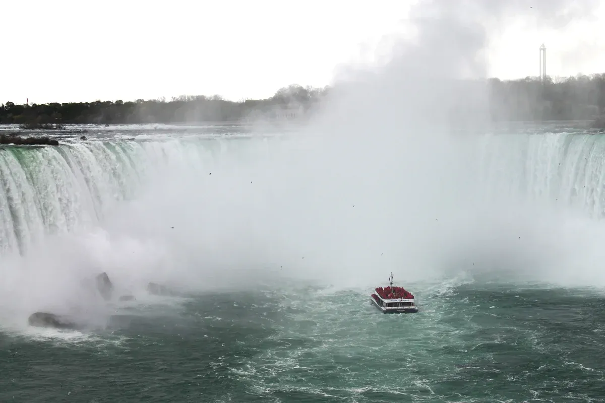 A Niagara City Cruises boat below the Horseshoe Falls on a Niagara Falls tour from Toronto